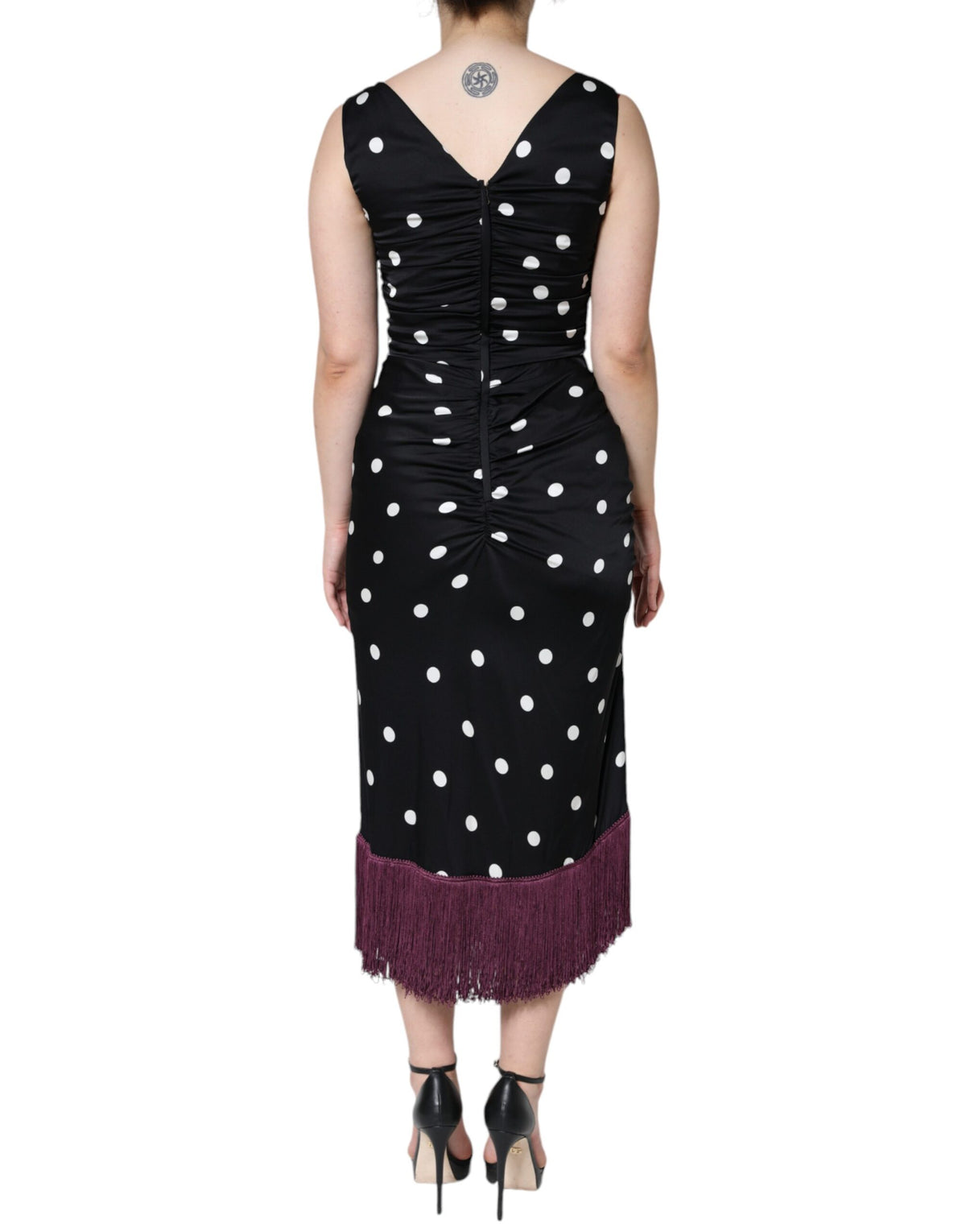 Experience the allure of the Dolce & Gabbana Black Silk Polka Dot V-neck Tassel Midi Dress, a masterpiece of Italian craftsmanship that embodies luxury and timeless elegance.