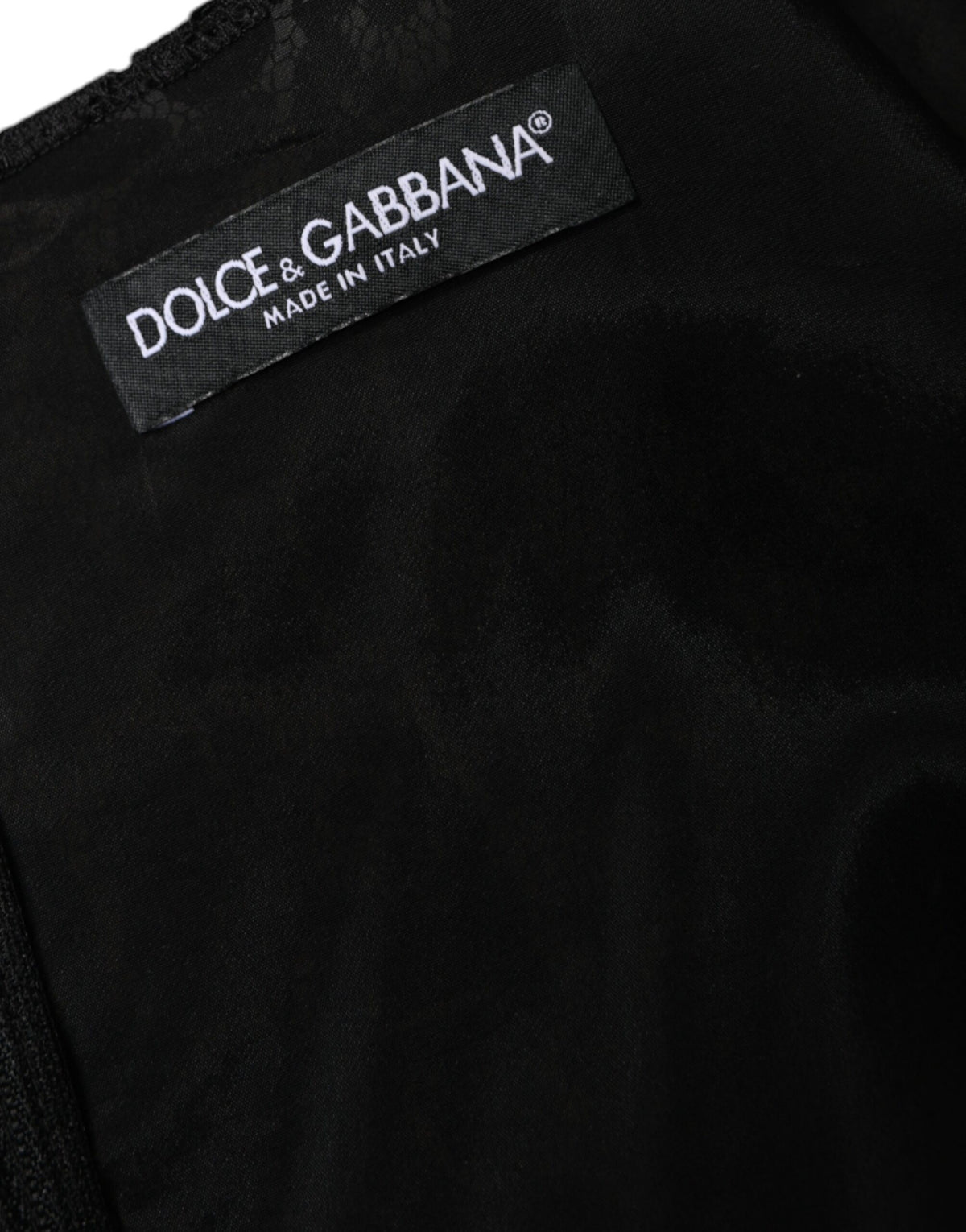 Indulge in the allure of the Dolce & Gabbana Black Floral Lace Sheath Mini Dress, a masterpiece of Italian craftsmanship that embodies timeless elegance and sophistication.