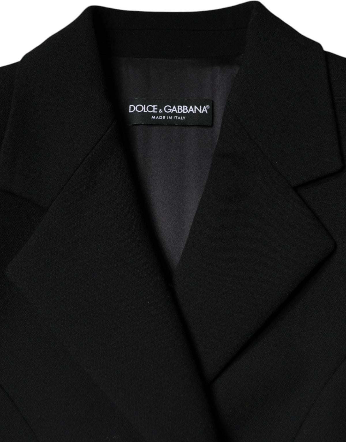 Elevate your style with the Dolce & Gabbana Black Double Breasted Trench Coat, a handcrafted masterpiece in virgin wool and silk, embodying timeless sophistication and allure.