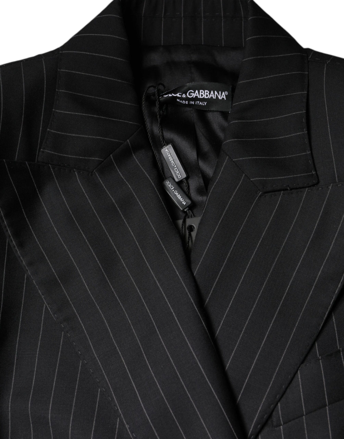 Elevate your wardrobe with the Dolce & Gabbana Black Striped Double Breasted Coat Jacket, a masterpiece of virgin wool and silk, embodying timeless elegance and Italian craftsmanship.
