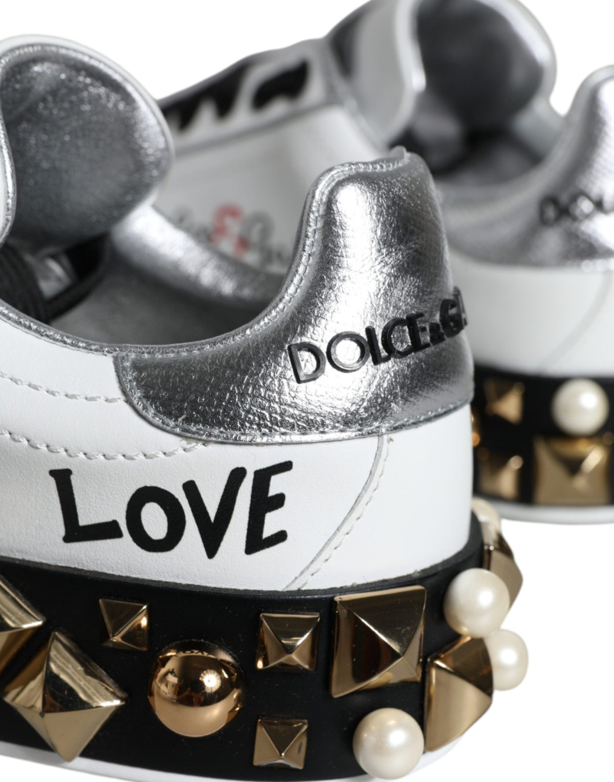 Step into a realm of elegance with Dolce & Gabbana's White Leather Floral Studded Sneakers, where exquisite craftsmanship meets luxurious allure for the discerning individual.