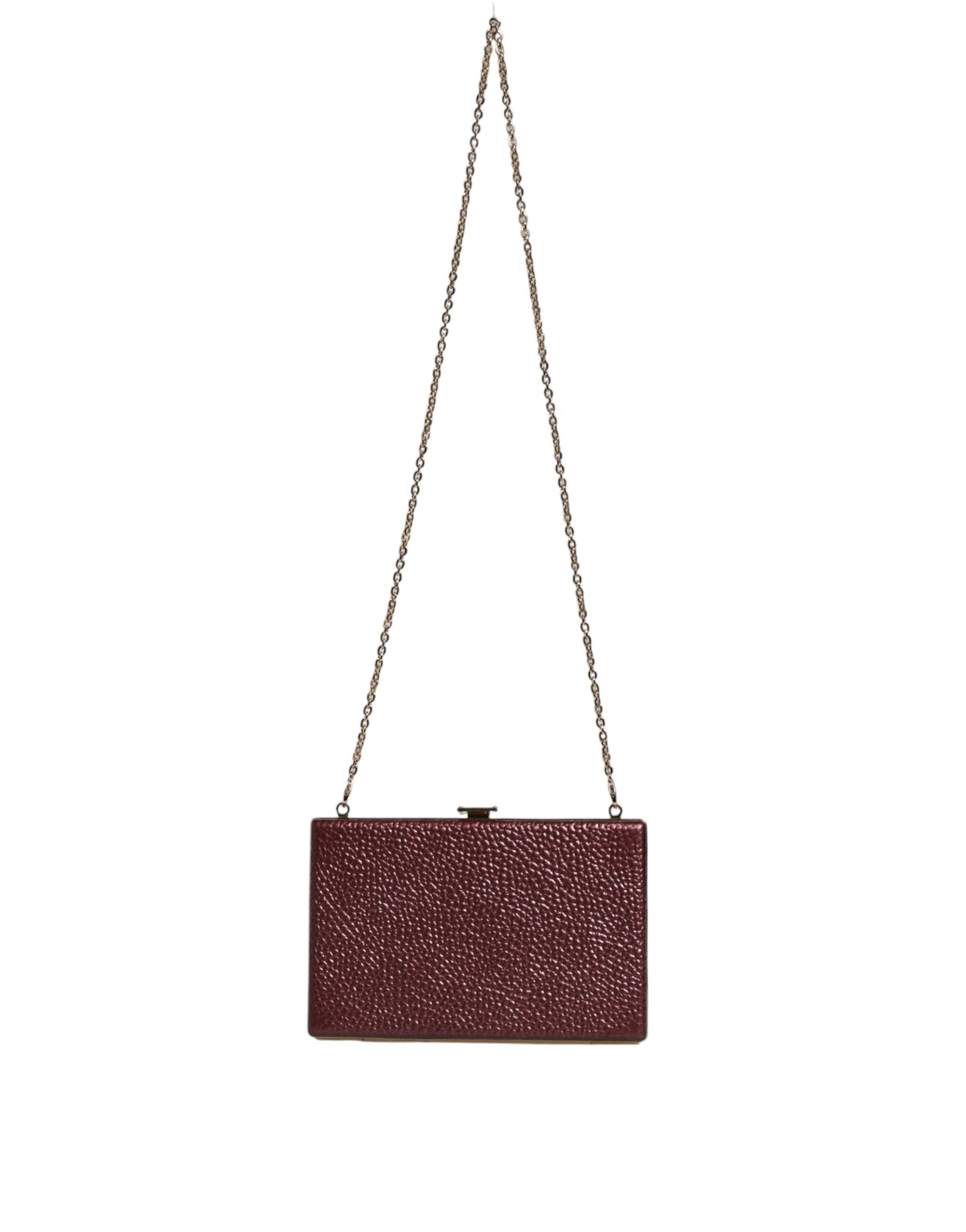 Elevate your elegance with the Dolce & Gabbana Maroon Leather Clutch, a luxurious blend of artisanal craftsmanship and timeless sophistication for every upscale occasion.