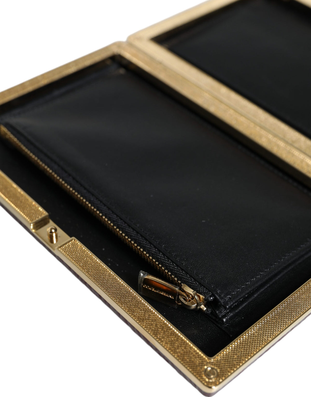 Elevate your elegance with the Dolce & Gabbana Maroon Leather Clutch, a luxurious blend of artisanal craftsmanship and timeless sophistication for every upscale occasion.