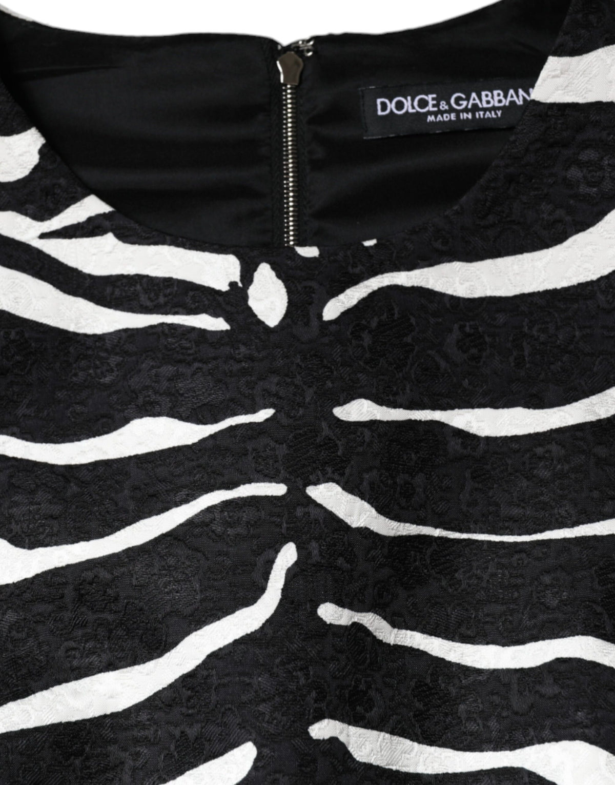 Discover the exquisite Dolce & Gabbana Black White Zebra A-line Sheath Mini Dress, a masterpiece of Italian craftsmanship blending luxurious viscose and cotton for timeless elegance.