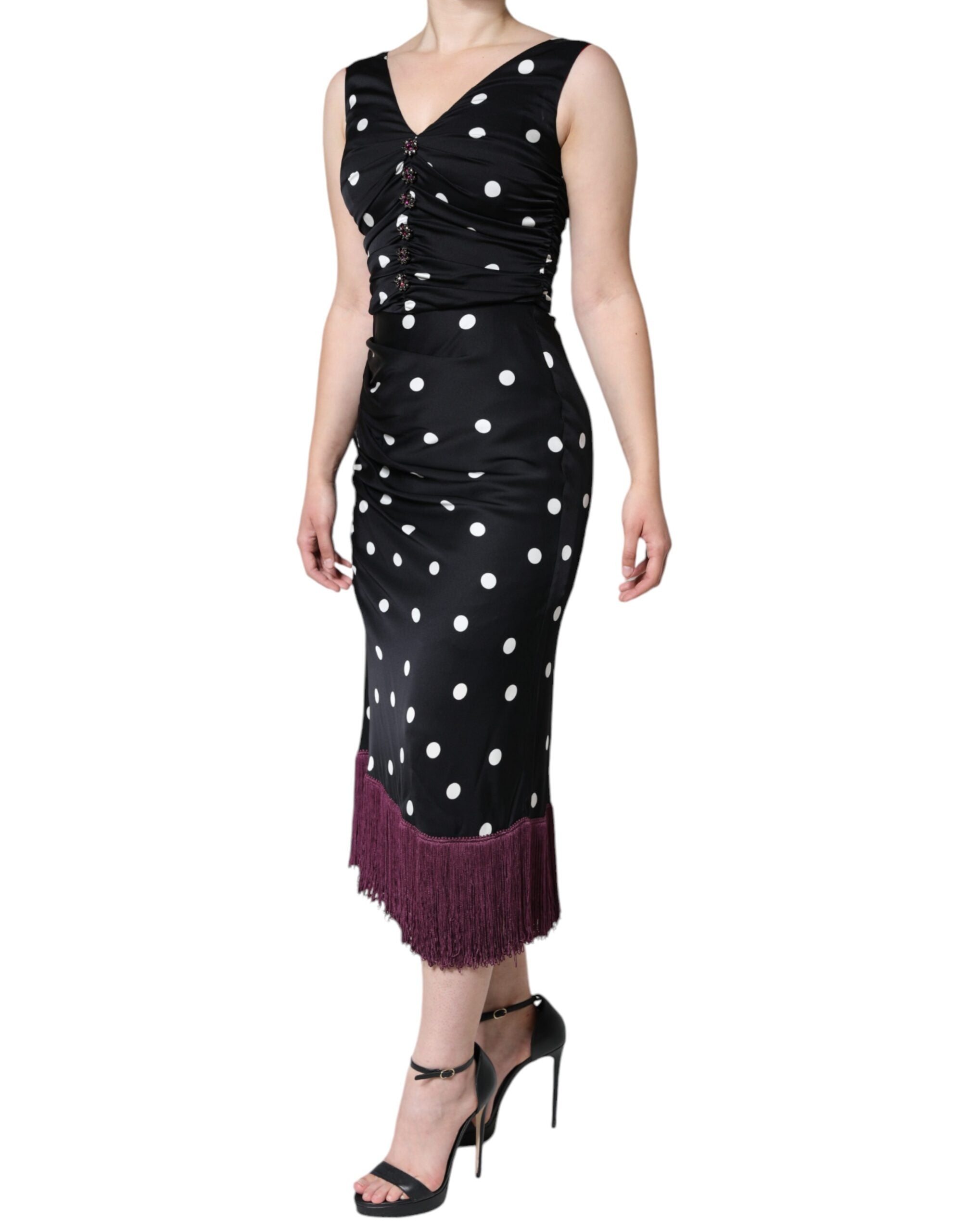 Indulge in the exquisite Dolce & Gabbana Black Silk Polka Dot Vneck Tassel Midi Dress, a timeless piece crafted from luxurious silk, embodying sophistication and allure.