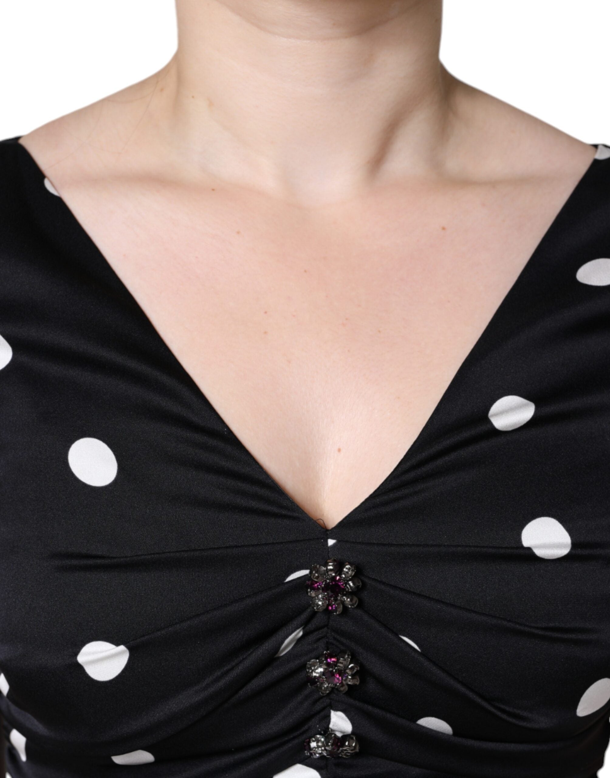 Experience the allure of the Dolce & Gabbana Black Silk Polka Dot Vneck Tassel Midi Dress, a testament to Italian craftsmanship and timeless elegance.