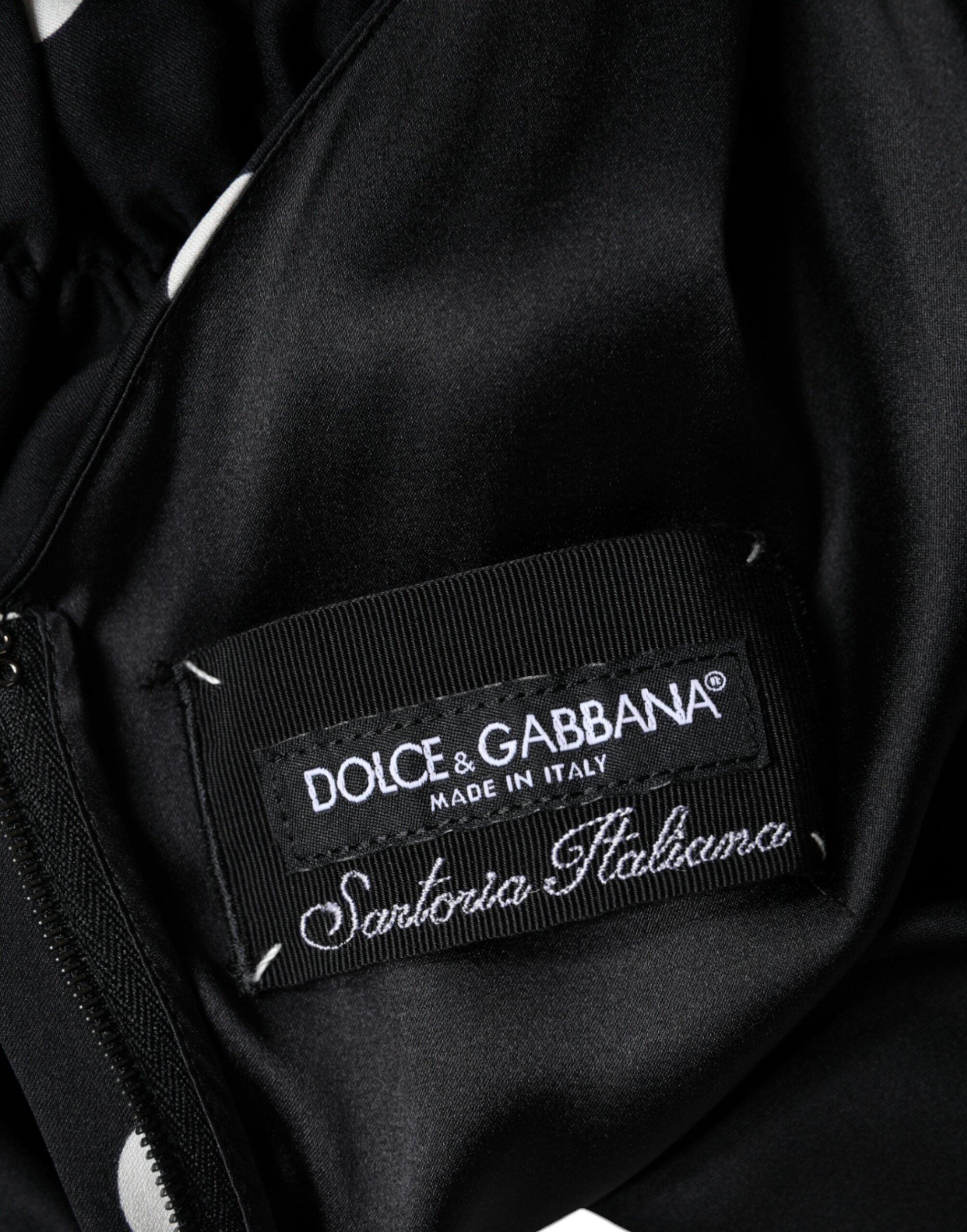 Indulge in the exquisite Dolce & Gabbana Black Silk Polka Dot Vneck Tassel Midi Dress, where luxurious silk meets timeless elegance, perfect for the discerning fashion connoisseur.