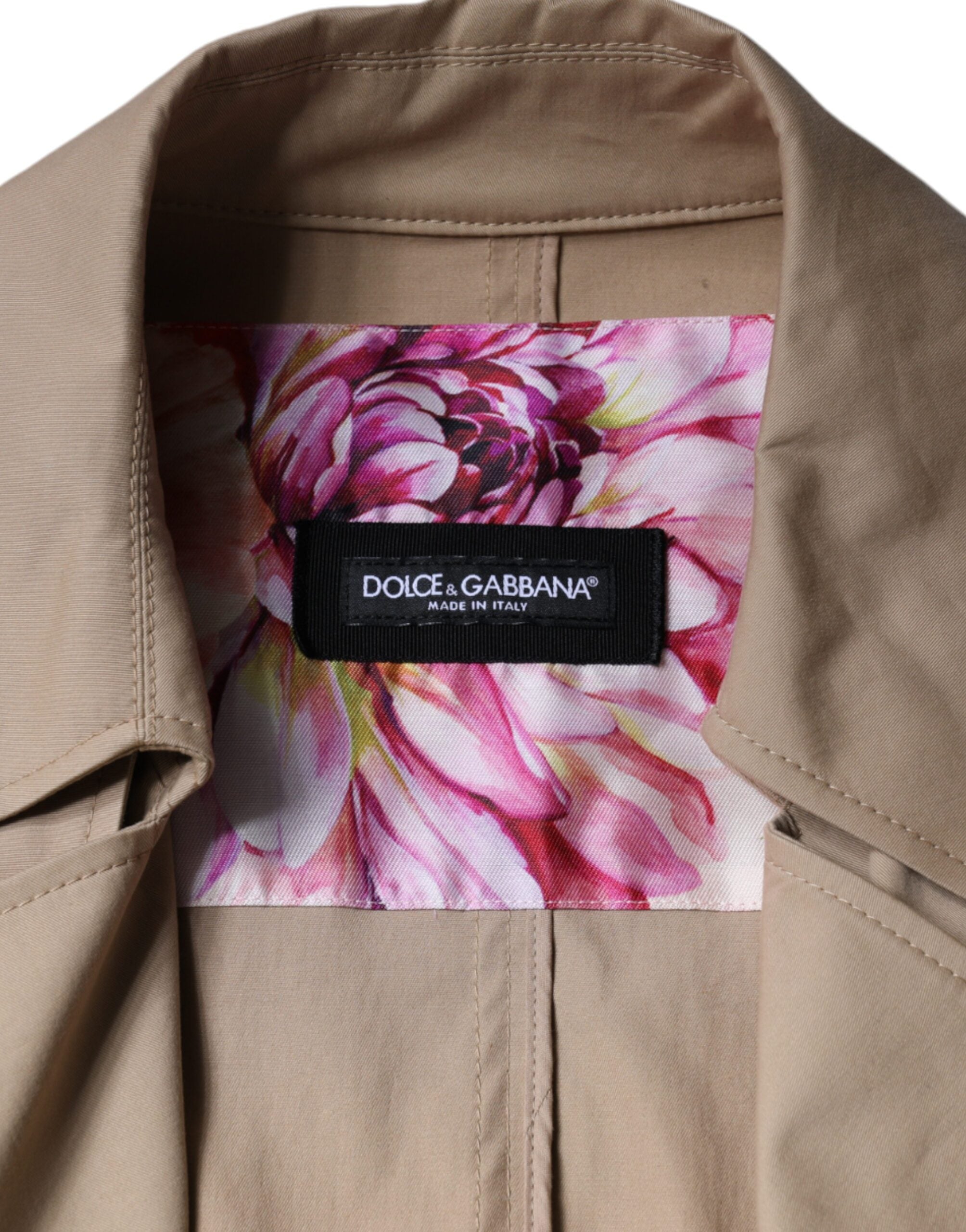 Elevate your style with the Dolce & Gabbana Khaki Double Breasted Trench Coat, a timeless blend of cotton and elastane, embodying exquisite Italian craftsmanship and luxury.