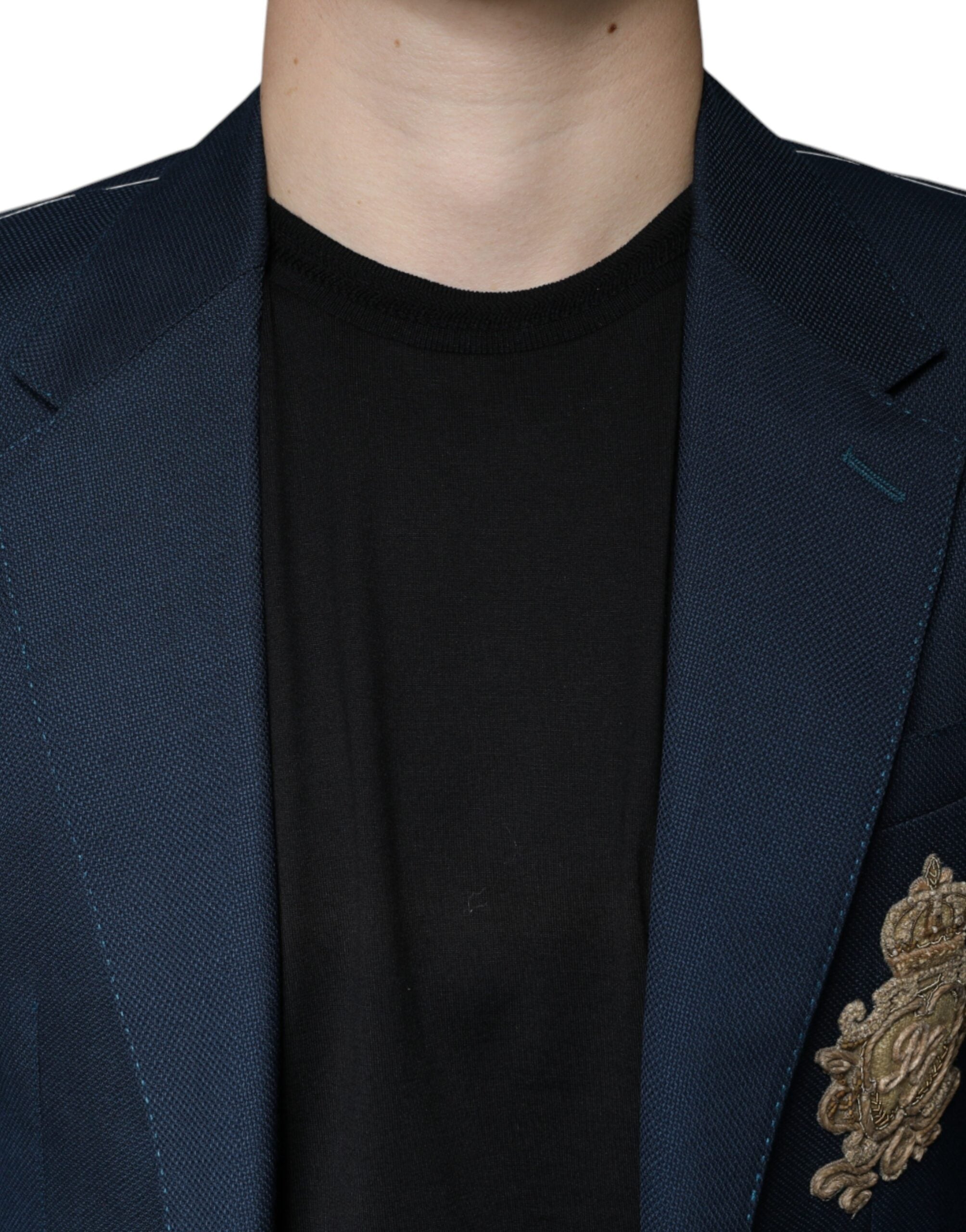 Indulge in the exquisite Dolce & Gabbana Blue Wool Logo Blazer, a masterpiece of Italian craftsmanship, blending luxurious virgin wool and silk for timeless elegance.