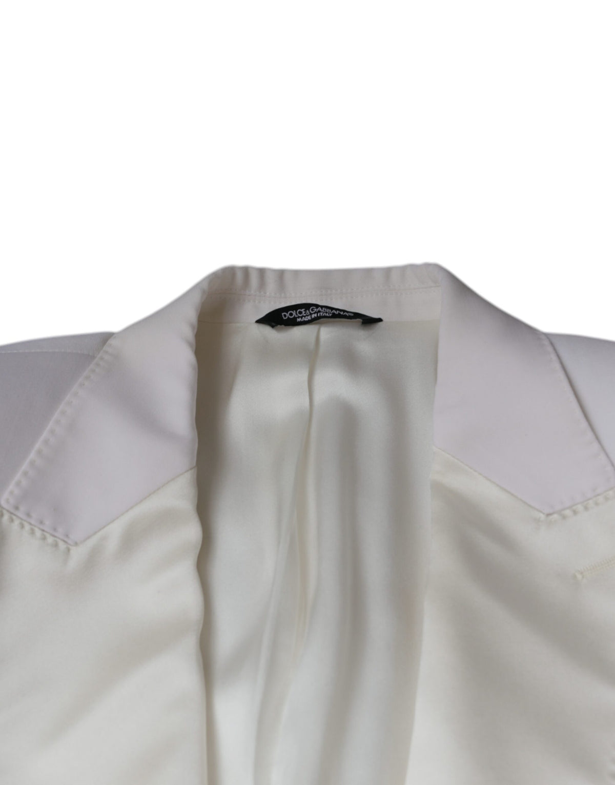 Discover the Dolce & Gabbana Off White Wool Single Breasted Dress Blazer, a masterpiece of virgin wool and silk, epitomizing luxury and timeless elegance for the discerning individual.