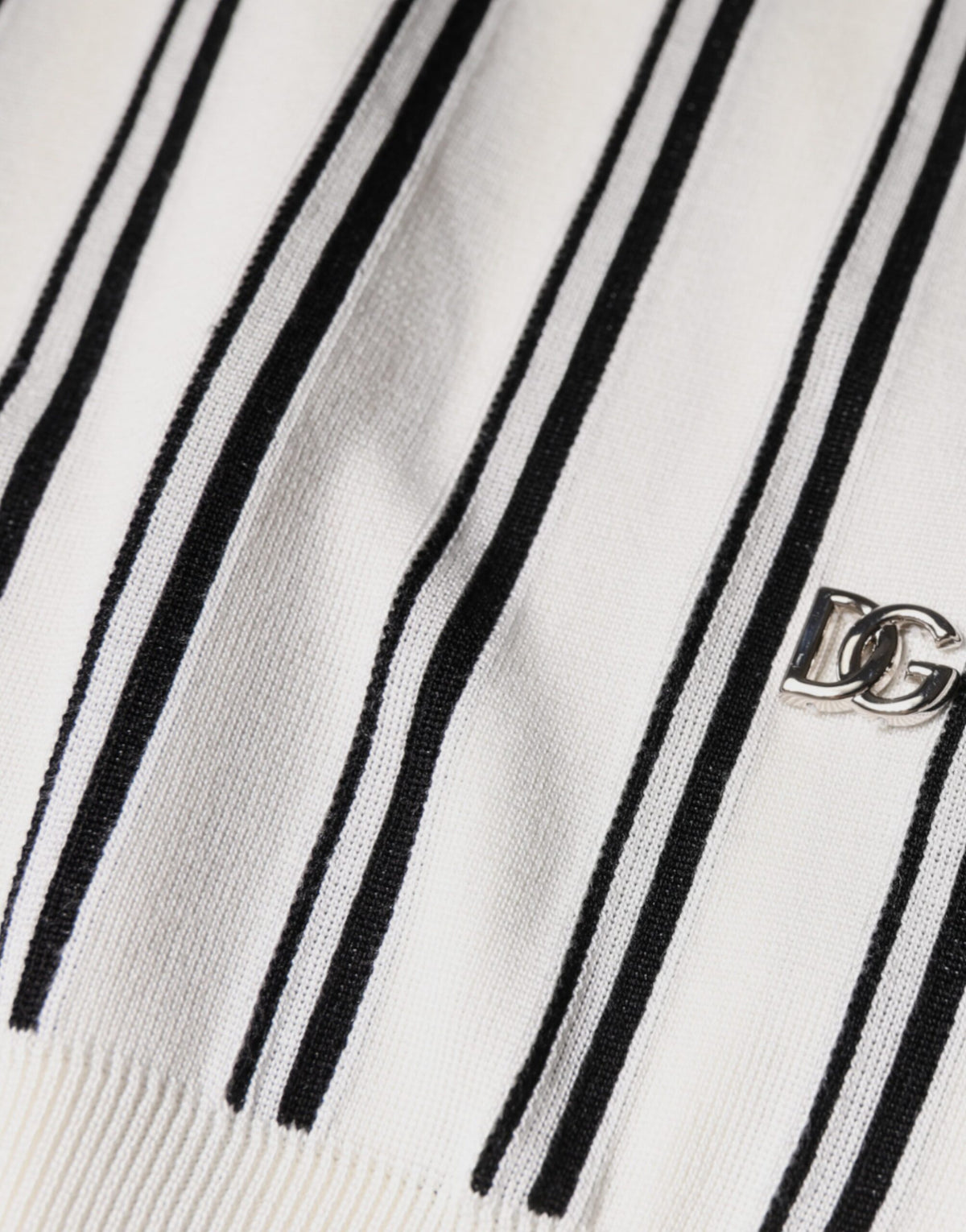 Indulge in the exquisite Dolce & Gabbana White Black Stripe Polo, crafted from luxurious silk, embodying sophistication and timeless elegance for the discerning individual.