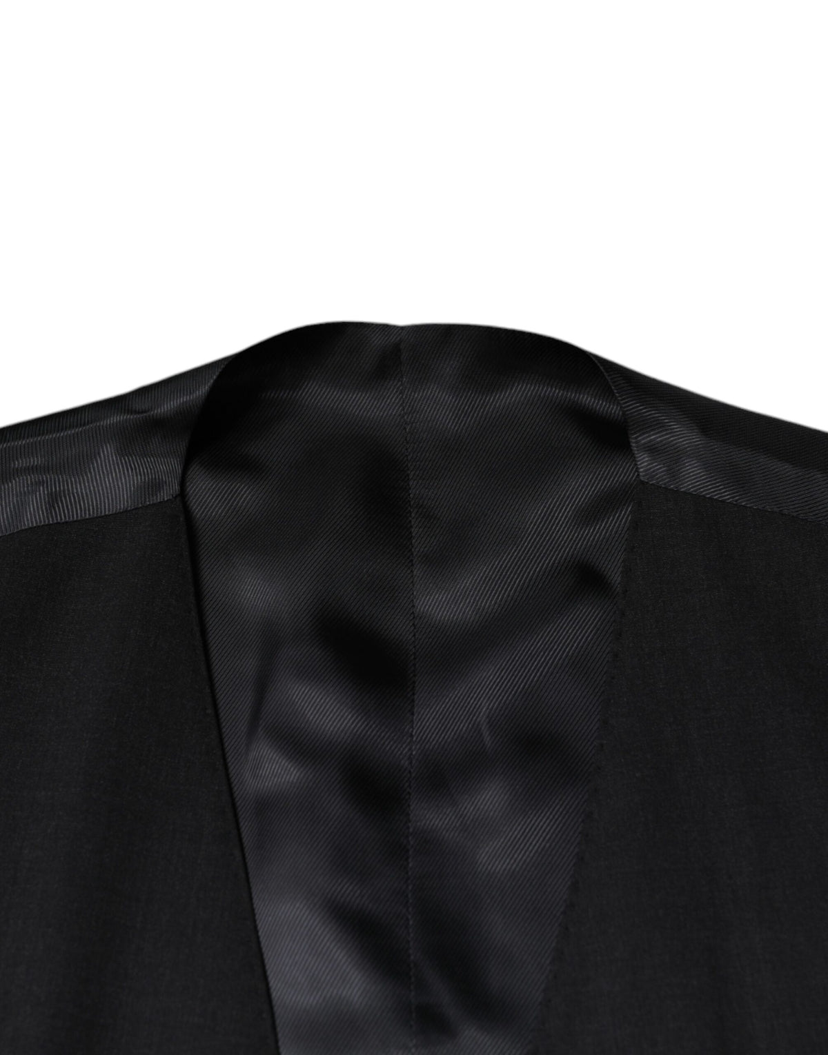 Elevate your wardrobe with the Dolce & Gabbana Black Wool Waistcoat, a masterpiece of luxury tailoring crafted from premium virgin wool, embodying timeless elegance and sophistication.