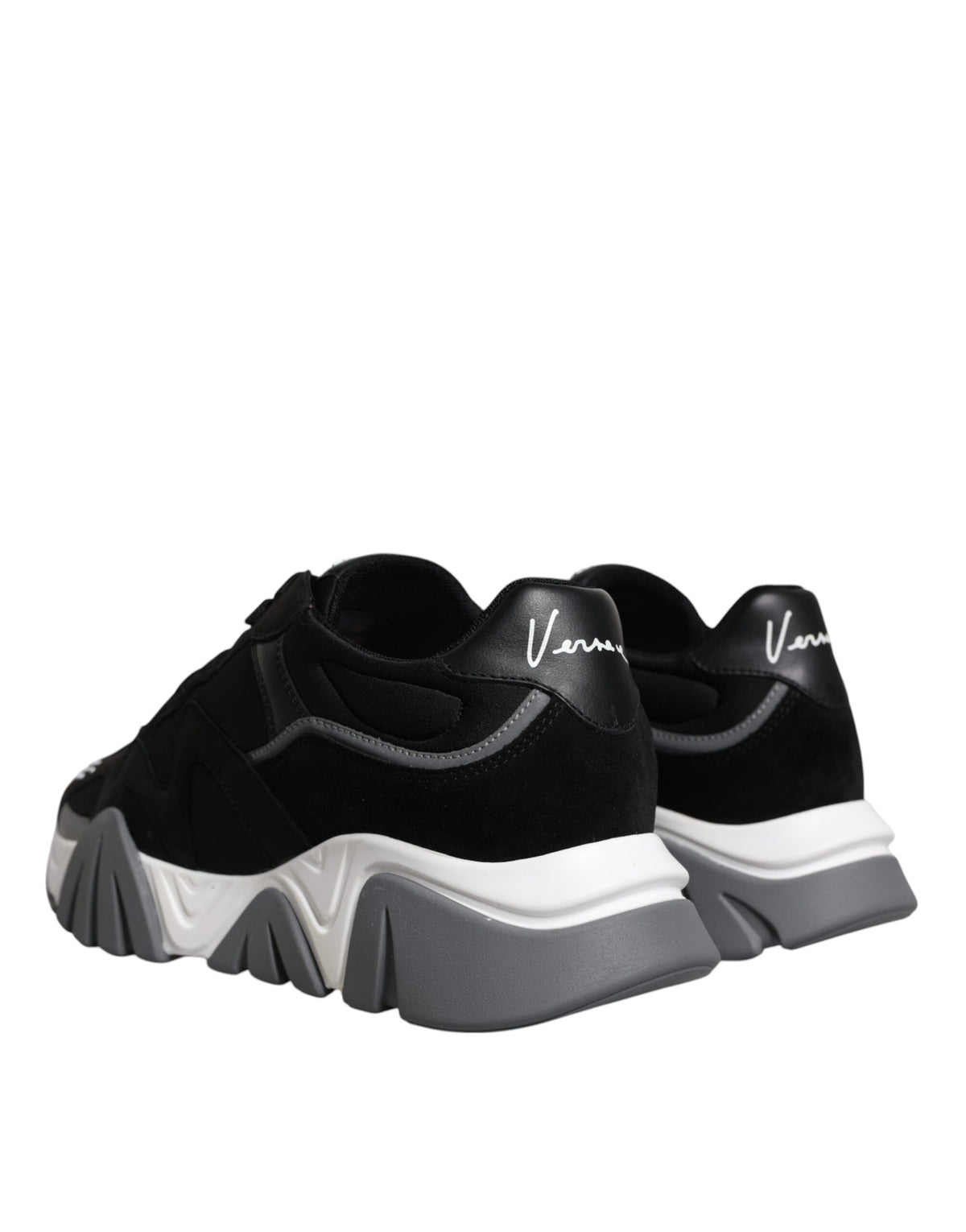 Indulge in the allure of Versace's Black Leather Neoprene Chunky Low Top Sneakers, where Italian craftsmanship meets bold elegance, perfect for any sophisticated ensemble.