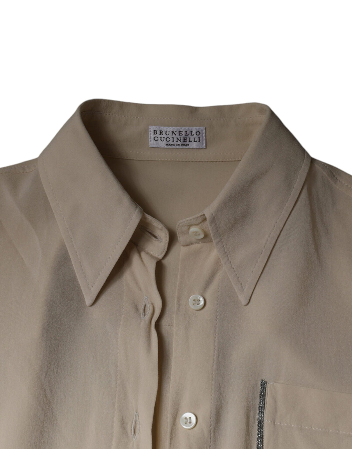 Indulge in the exquisite Brunello Cucinelli Beige Silk Blend Collared Button Down Top, where luxurious silk meets timeless elegance, perfect for the discerning connoisseur.
