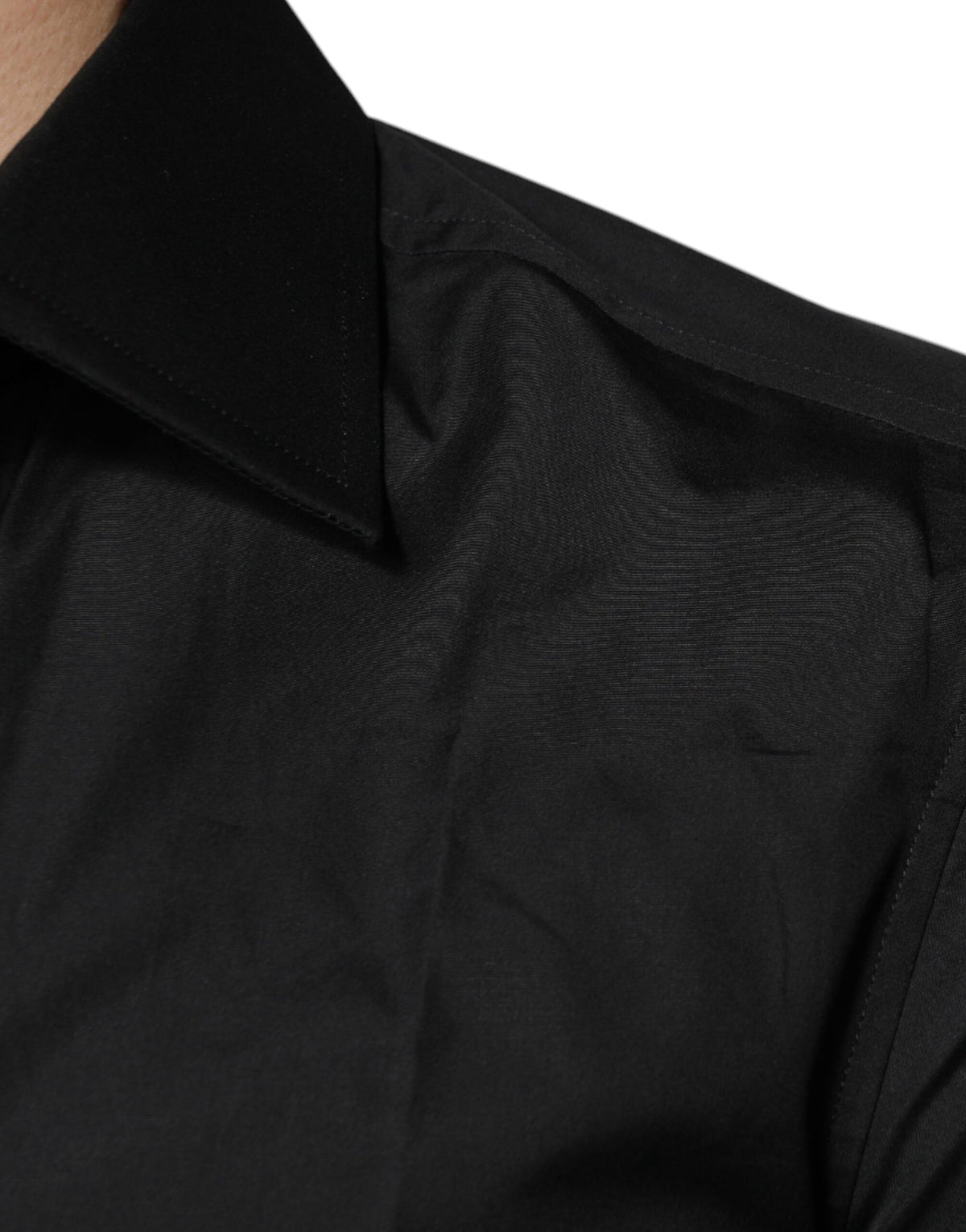 Elevate your wardrobe with the Dolce & Gabbana Black Cotton Formal Long Sleeves Dress Shirt, a masterpiece of exquisite craftsmanship and timeless elegance, perfect for any sophisticated occasion.