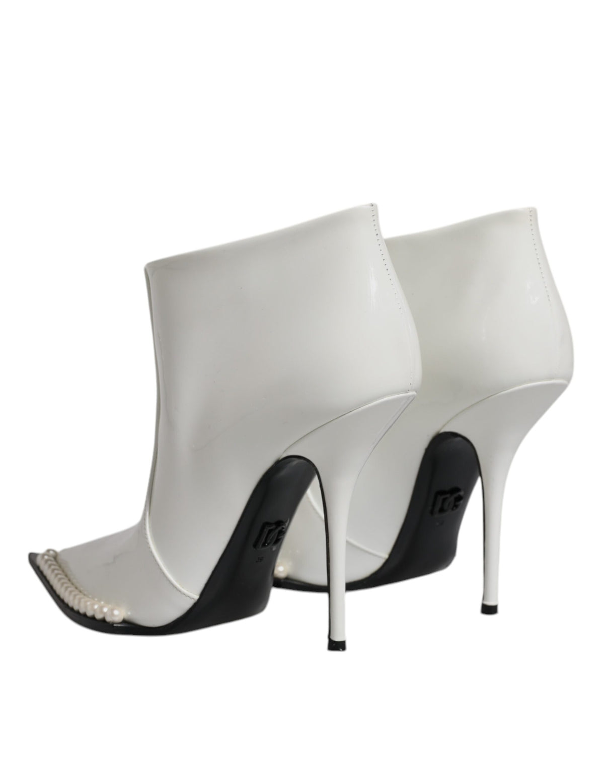 Discover the allure of Dolce & Gabbana's White Faux Pearl Leather Ankle Boots, where exquisite calf leather meets timeless elegance, perfect for the discerning individual.