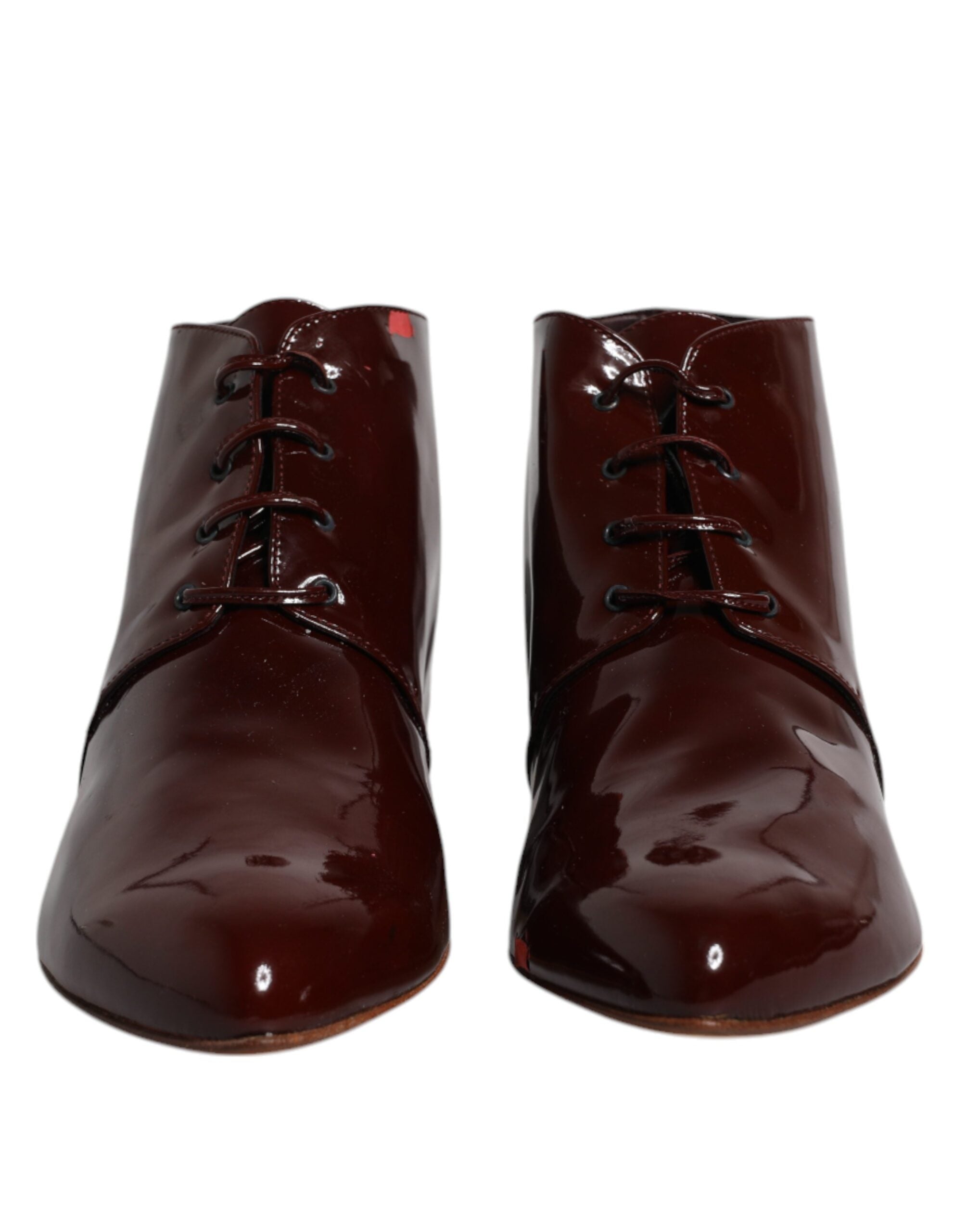 Discover the allure of Dolce & Gabbana's Maroon Leather Lace Up Ankle Boots, where exquisite Italian craftsmanship meets timeless elegance, perfect for the discerning individual.
