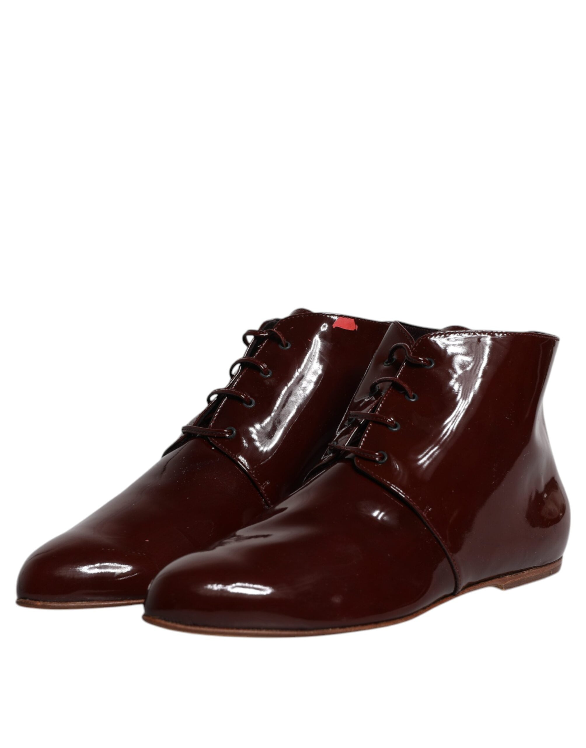 Indulge in the exquisite allure of Dolce & Gabbana's Maroon Leather Lace Up Ankle Boots, where Italian craftsmanship meets timeless elegance for the discerning individual.