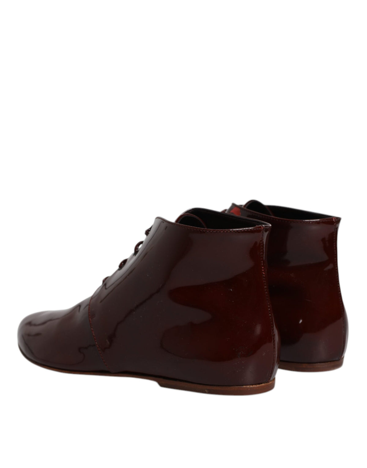 Indulge in the exquisite Dolce & Gabbana Maroon Leather Lace Up Ankle Boots, where Italian craftsmanship meets timeless elegance, perfect for the discerning lover of luxury.