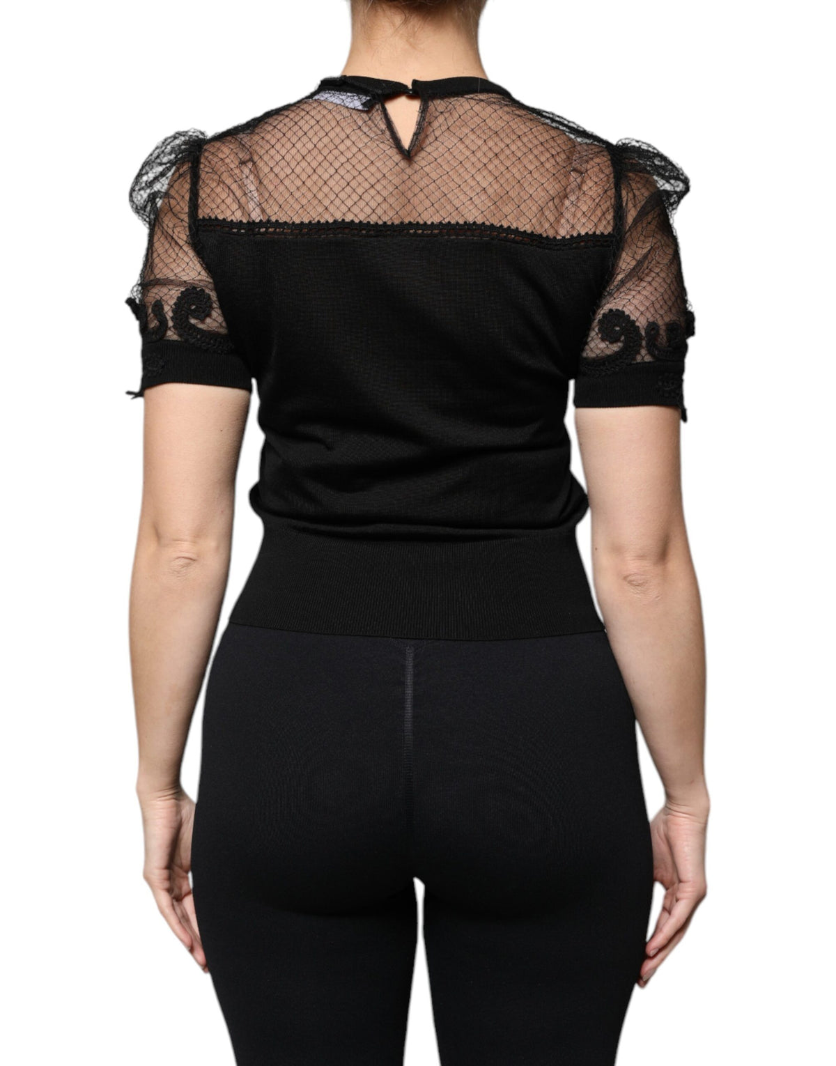Indulge in the exquisite Dolce & Gabbana Black Floral Lace Short Sleeves Blouse, a masterpiece of silk and lace that embodies Italian luxury and timeless elegance.
