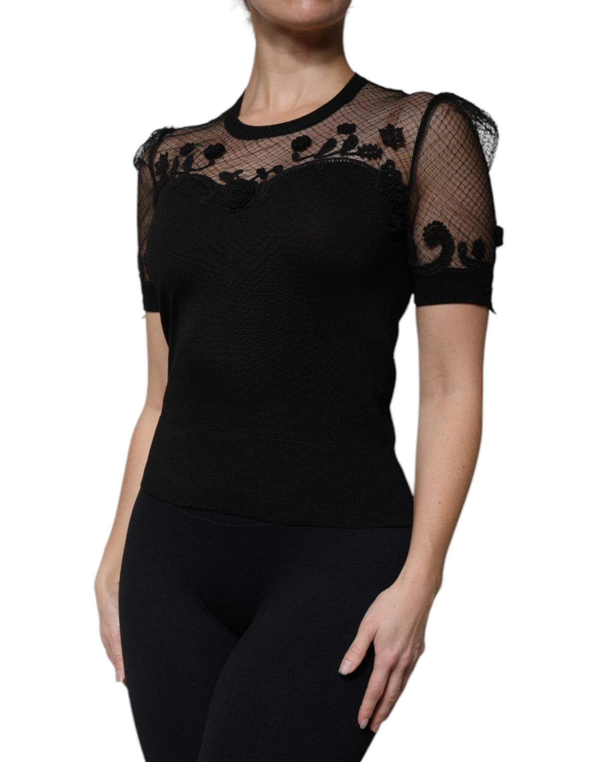 Indulge in the exquisite allure of Dolce & Gabbana's Black Floral Lace Blouse, a timeless masterpiece crafted from a luxurious silk blend, embodying elegance and sophistication.