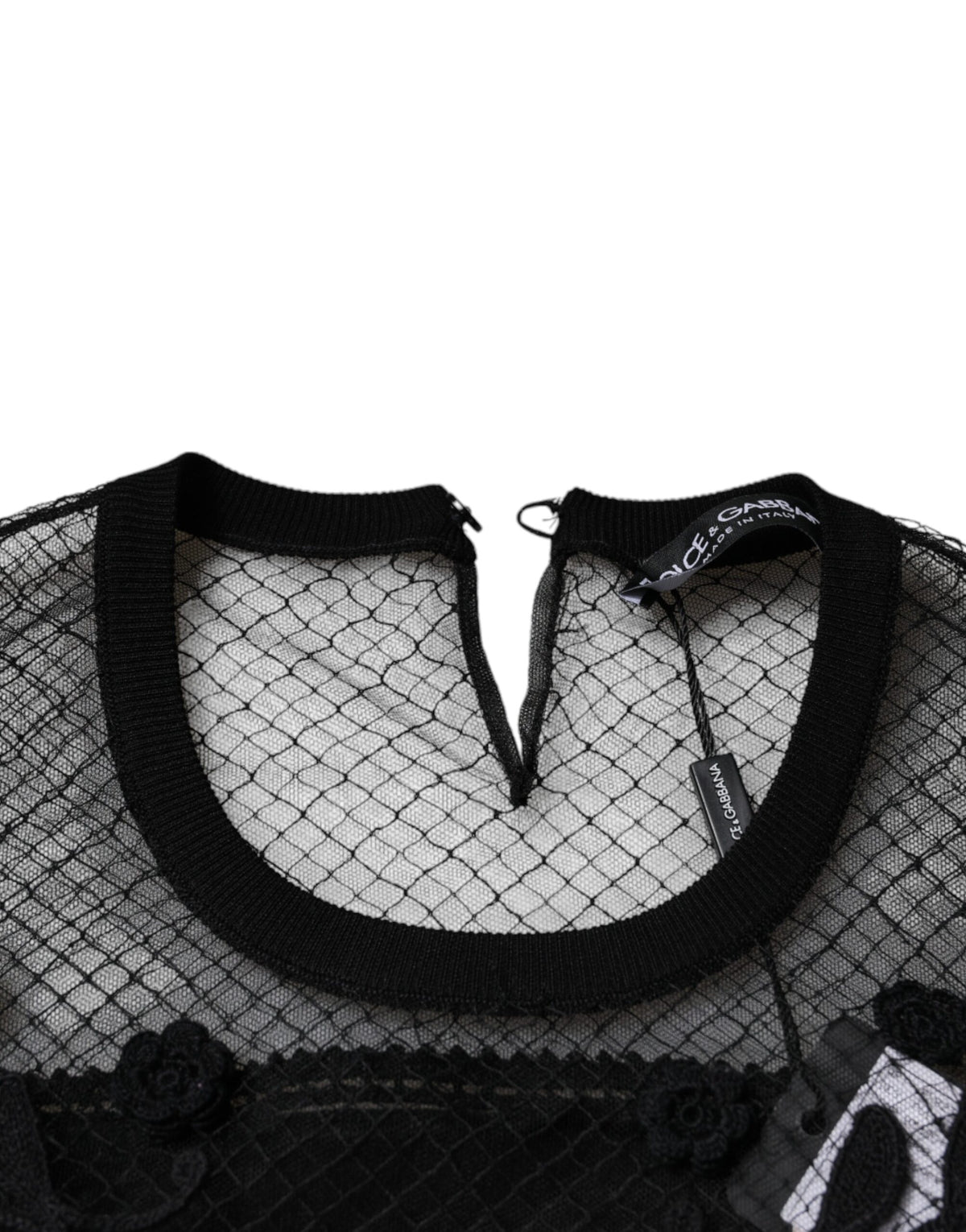 Indulge in the exquisite Dolce & Gabbana Black Floral Lace Blouse, a masterpiece of silk and lace that embodies timeless elegance and Italian craftsmanship for the discerning individual.
