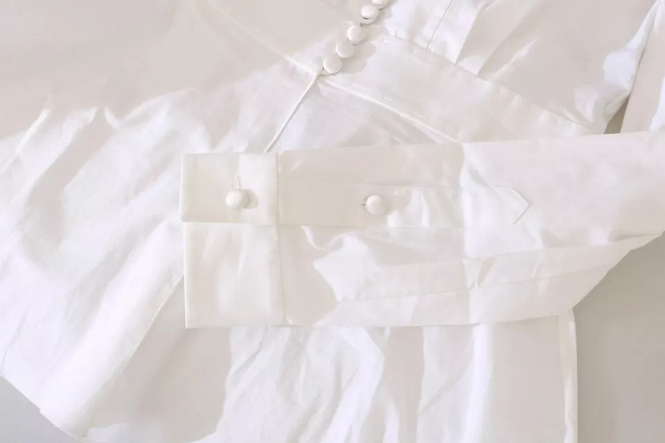 Elevate your wardrobe with the Dolce & Gabbana Black White Decorative Buttons Blouse, a masterpiece of Italian craftsmanship in luxurious cotton and elastane, embodying timeless elegance.