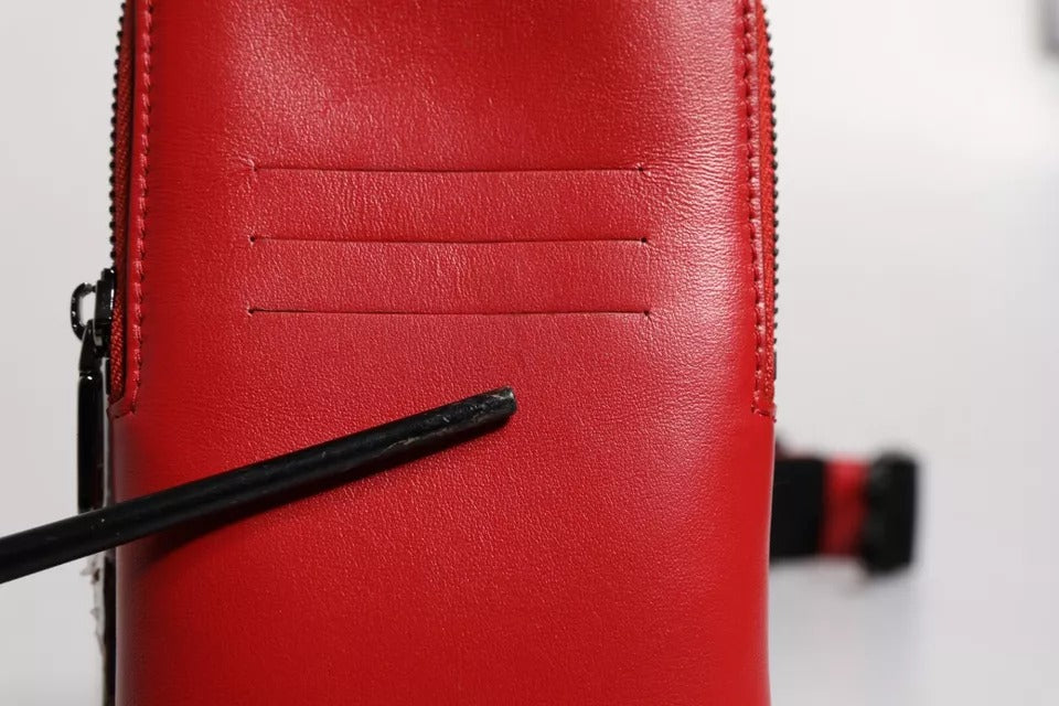 Experience the allure of Dolce & Gabbana's Red Leather Logo Zip Around Card Holder, a masterpiece of Italian craftsmanship that embodies luxury and sophistication for the discerning individual.