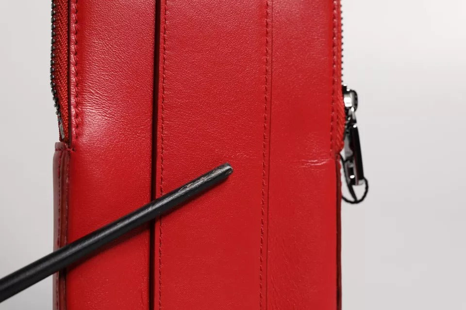 Elevate your style with the Dolce & Gabbana Red Leather Logo Zip Around Card Holder Wallet, a timeless blend of exquisite craftsmanship and luxurious design, perfect for discerning tastes.