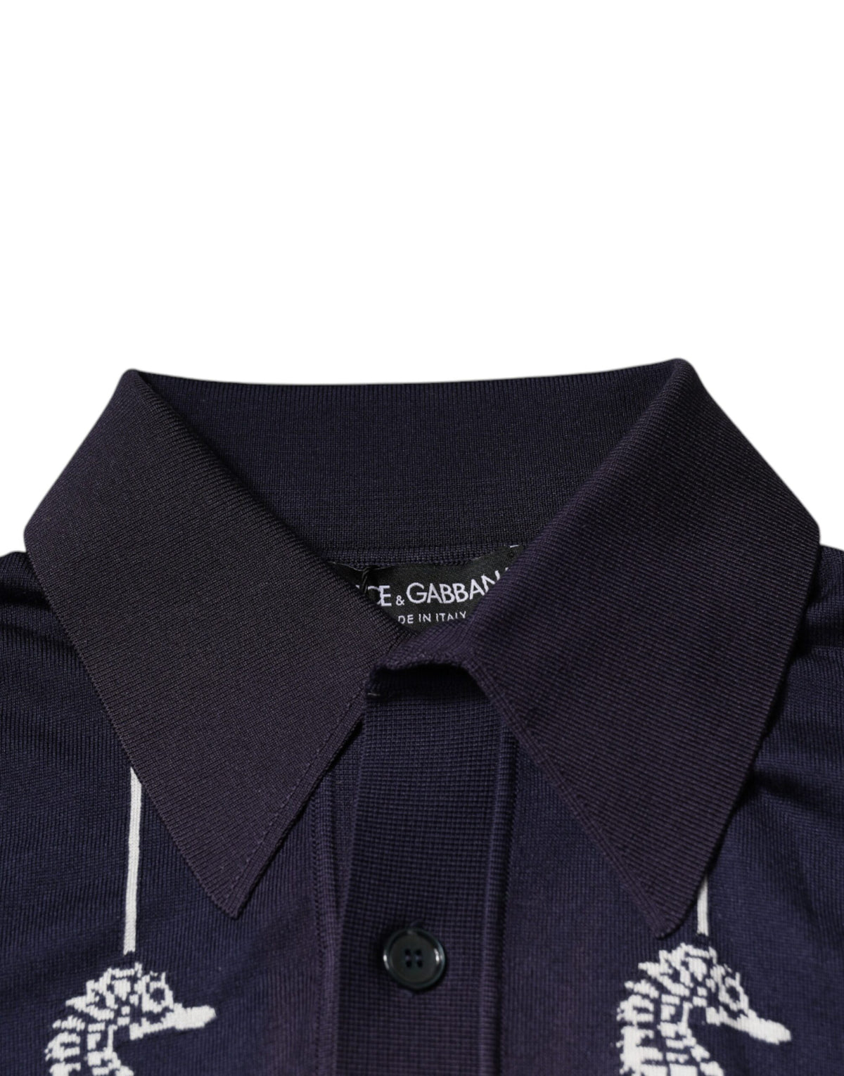 Indulge in the exquisite Dolce & Gabbana Dark Blue Sea Horse Collared Polo T-shirt, a silk masterpiece that embodies timeless elegance and sophisticated allure.