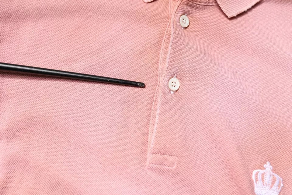 Indulge in the exquisite Dolce & Gabbana Pink Crown Collared Polo, a luxurious blend of 100% cotton and Italian craftsmanship, perfect for elevating your style.