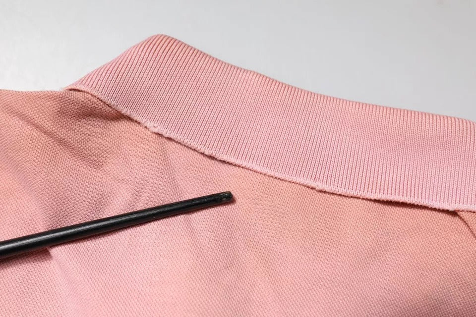 Experience the allure of Dolce & Gabbana's Pink Crown Collared Polo T-shirt, crafted from 100% cotton, embodying Italian luxury and timeless elegance for the discerning individual.