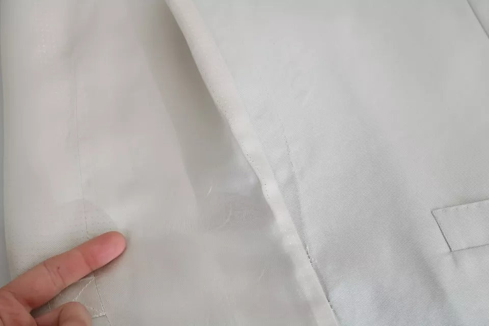 Elevate your wardrobe with the Dolce & Gabbana Off-White Cotton Silk Formal Coat Vest, a masterpiece of Italian craftsmanship that embodies timeless elegance and sophisticated allure.