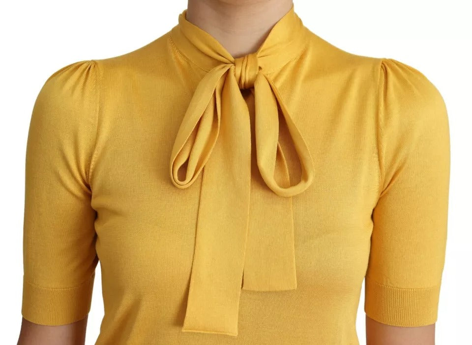 Elevate your wardrobe with the Dolce & Gabbana Yellow Silk Knit Pullover, a luxurious statement piece crafted from 100% silk, embodying timeless elegance and sophistication.