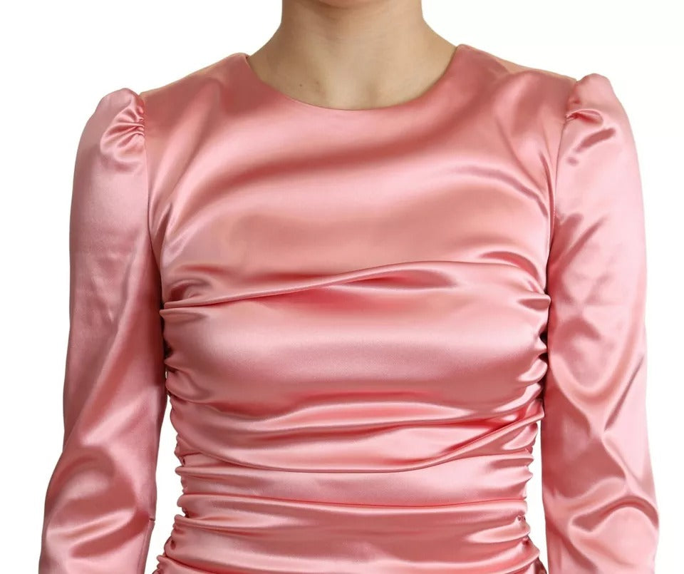 Indulge in the exquisite allure of the Dolce & Gabbana Pink Long Sleeves Bodycon Sheath Midi Dress, a masterpiece of luxurious craftsmanship designed to elevate your wardrobe with timeless elegance.