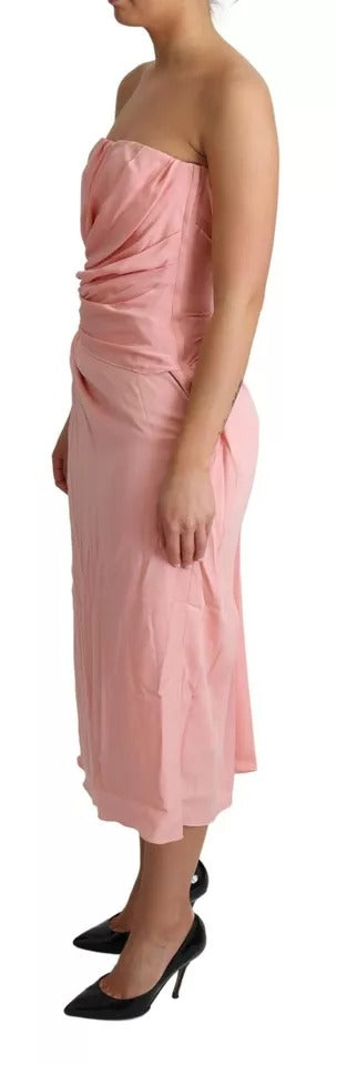 Indulge in the exquisite allure of the Dolce & Gabbana Pink Silk Stretch Strapless Sheath Midi Dress, a timeless piece crafted in Italy that embodies luxury and elegance.