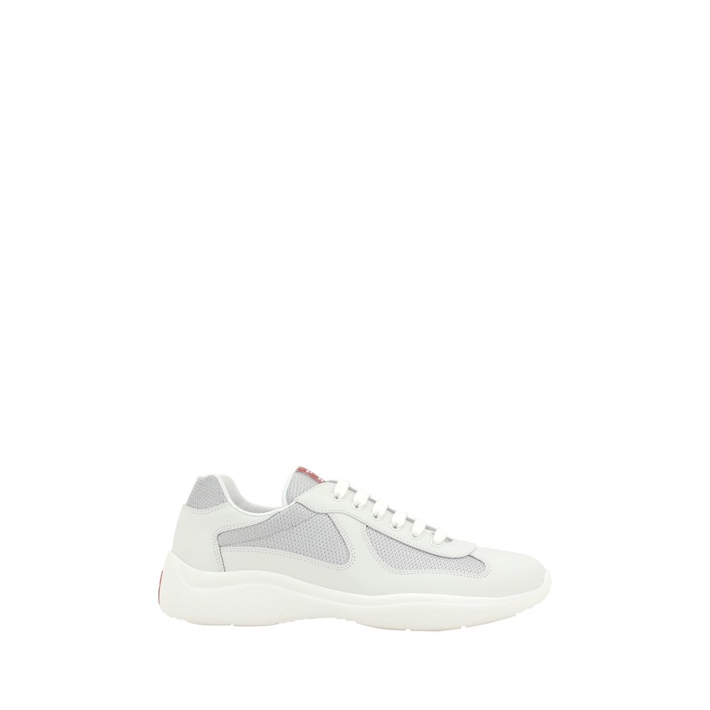 Indulge in the elegance of Prada's White Calf Leather Bos Taurus Low Top Sneakers, where exquisite craftsmanship meets luxurious comfort for the discerning connoisseur.