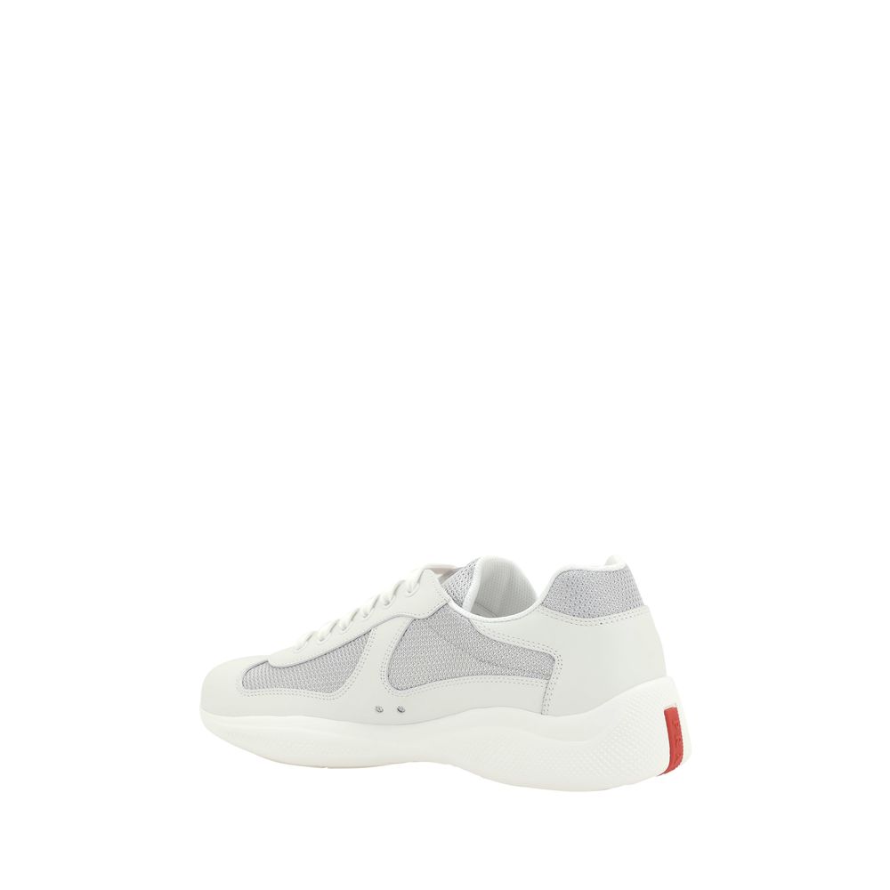 Step into luxury with Prada's White Calf Leather Bos Taurus Low Top Sneakers, where exquisite craftsmanship meets timeless elegance for the discerning individual.