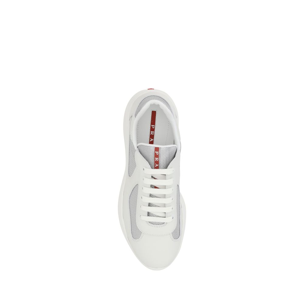 Indulge in the exquisite allure of Prada's White Calf Leather Bos Taurus Low Top Sneakers, where luxurious craftsmanship meets timeless elegance for the discerning individual.