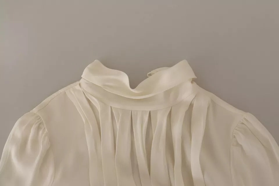 Indulge in the exquisite Dolce & Gabbana Off White Silk Long Sleeve Turtle Neck Top, a luxurious blend of silk and elastane that embodies Italian craftsmanship and timeless elegance.