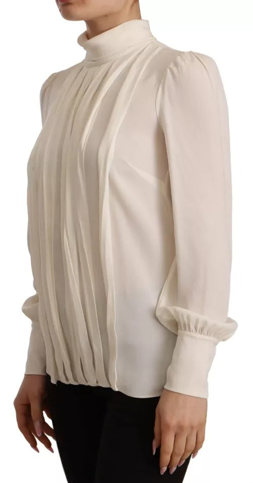 Elevate your wardrobe with the Dolce & Gabbana Off White Silk Long Sleeve Turtle Neck Top, a masterpiece of Italian craftsmanship that embodies timeless elegance and luxurious allure.
