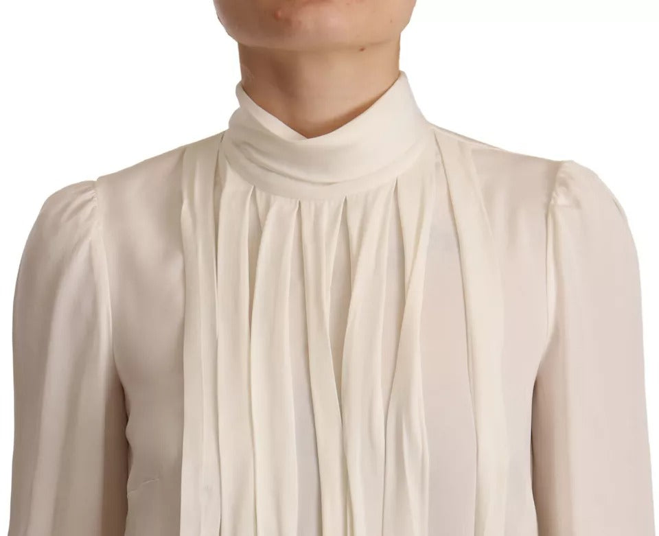 Elevate your wardrobe with the Dolce & Gabbana Off White Silk Long Sleeve Turtle Neck Top, a masterpiece of Italian craftsmanship that embodies luxurious elegance and timeless allure.