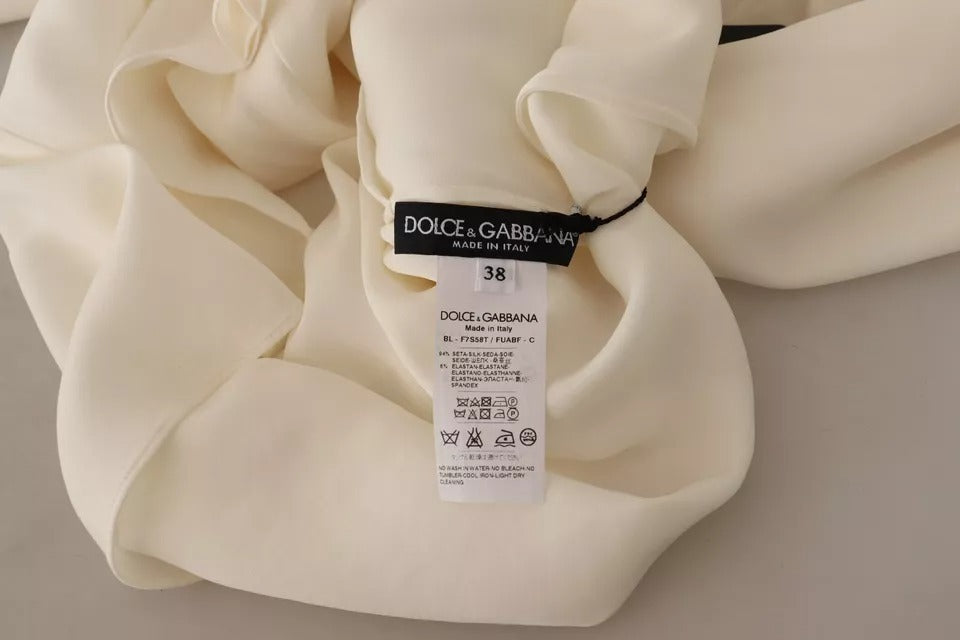 Indulge in the exquisite Dolce & Gabbana Off White Silk Long Sleeve Turtle Neck Top, a masterpiece of Italian craftsmanship that embodies luxury and elegance for the discerning individual.