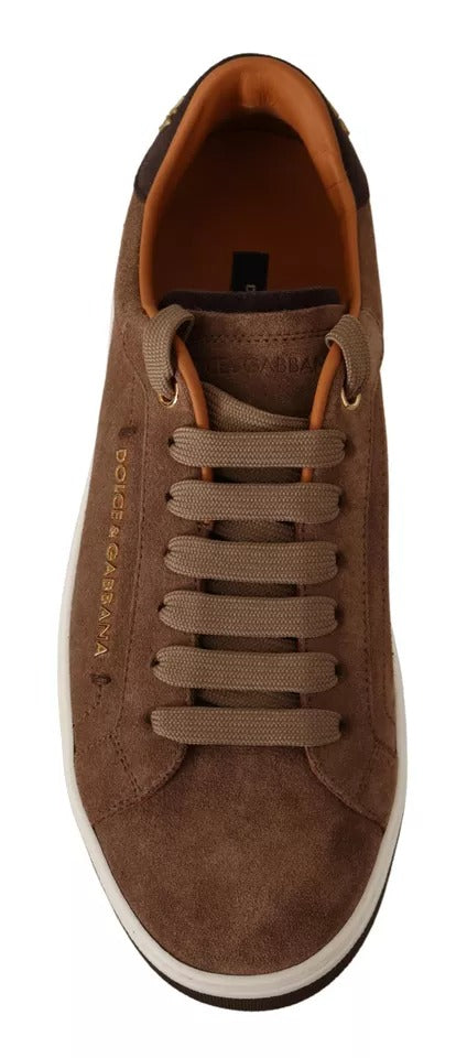 Experience the exquisite allure of Dolce & Gabbana's Brown Suede Logo Low Top Sneakers, where Italian craftsmanship meets timeless elegance for the discerning individual.