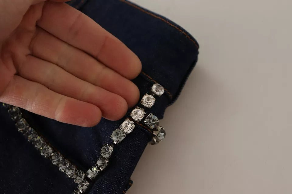 Elevate your summer wardrobe with Dolce & Gabbana's Dark Blue Embellished Denim Hot Pants, where exquisite craftsmanship meets luxurious allure, perfect for the confident individual.