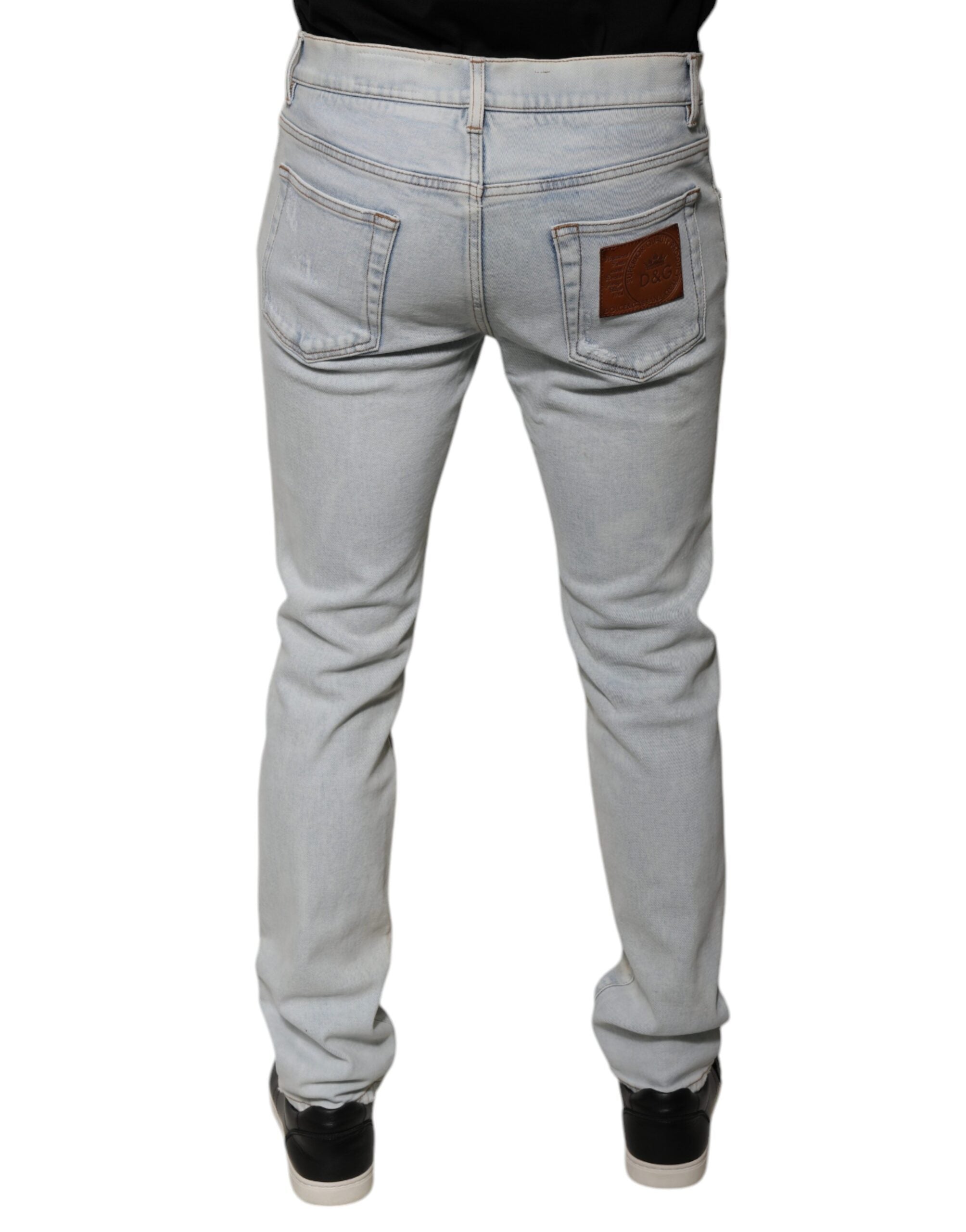 Experience the allure of Dolce & Gabbana's Light Blue Cotton Blend Tattered Skinny Denim Jeans, where Italian craftsmanship meets contemporary elegance for the discerning individual.