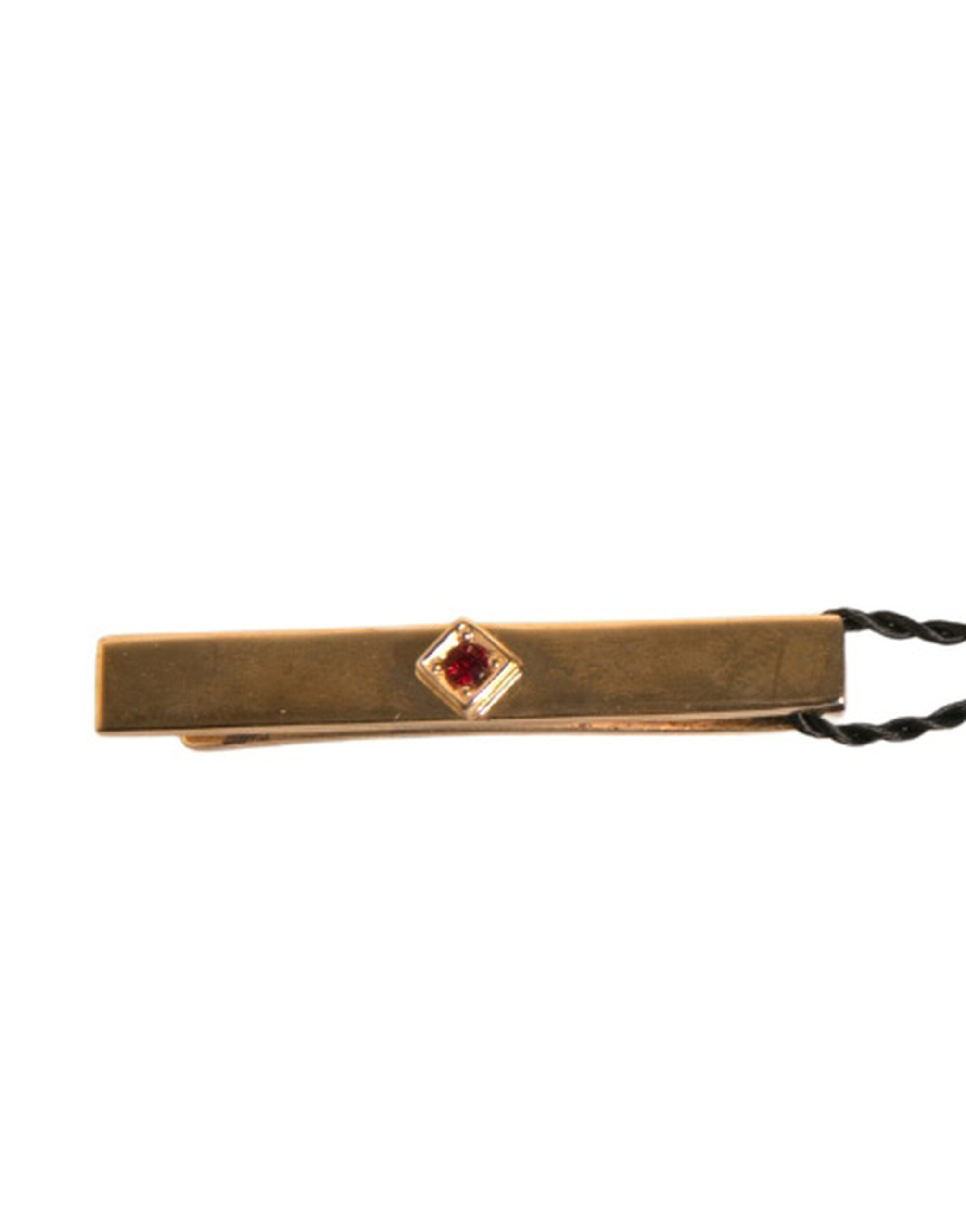 Discover the Dolce & Gabbana Gold Tone Brass Crystal Tie Clip Bar, a symbol of elegance and sophistication, crafted in Italy to elevate your style with timeless allure.
