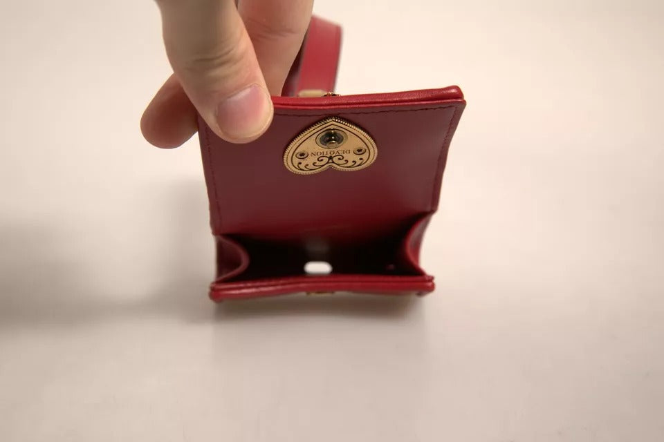 Elevate your style with the Dolce & Gabbana Black Leather Devotion Heart Strap Airpod Case, crafted from sumptuous lamb leather, embodying elegance and sophistication for the discerning individual.