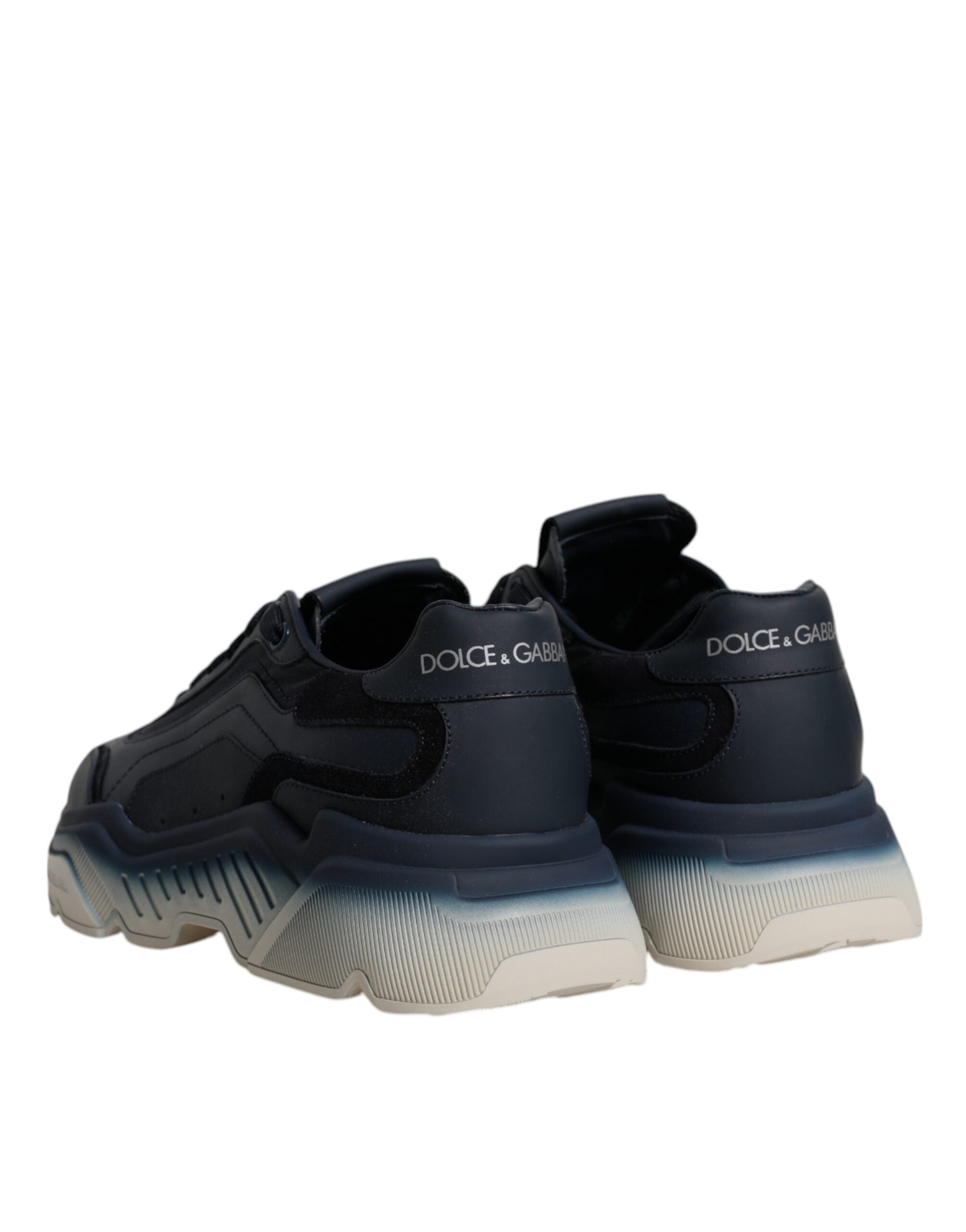 Step into the realm of sophistication with Dolce & Gabbana's Navy Blue Daymaster Low Top Sneakers, crafted from premium calf leather and nylon, embodying modern luxury and timeless elegance.