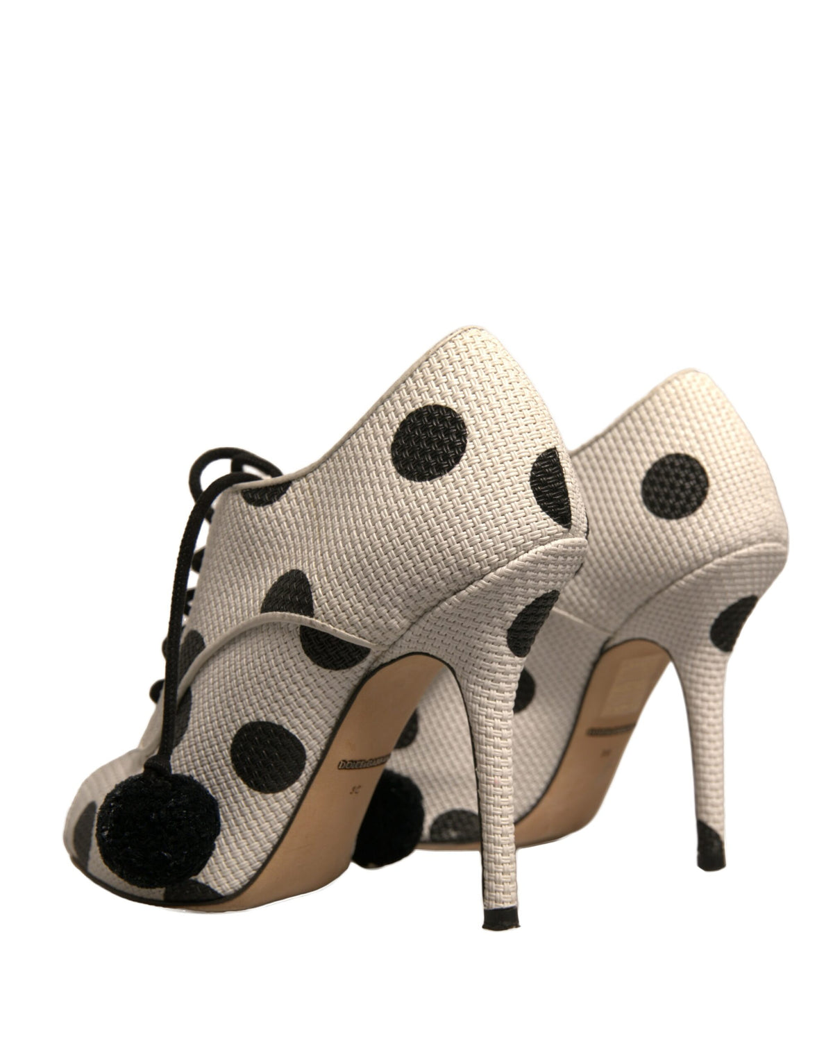 Step into refined elegance with Dolce & Gabbana's polka dot peep toe ankle boots, where luxurious leather meets playful artistry, embodying timeless sophistication.